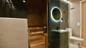 A modern bathroom with a glass-enclosed shower, a wooden vanity, and a white toilet. - Villa QUU C,  Premium 4BD Villa with Sauna (Kolari)