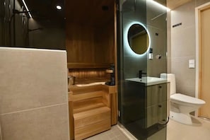 A modern bathroom with a glass-enclosed shower, a wooden vanity, and a white toilet. - Villa QUU C,  Premium 4BD Villa with Sauna (Kolari)