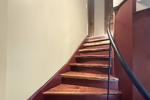 A staircase with wooden steps and a metal handrail. - Free Ruby Falls Ticket & More-Hot Tub-Handcrafted Cabin with Tower-Lookout Mountain-Romantic Getaway (Lookout Mountain)