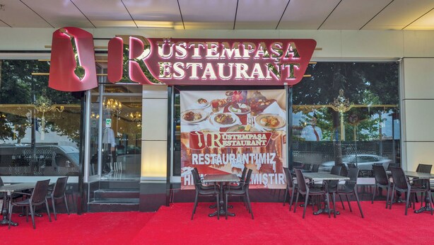 A restaurant with a red carpet and outdoor seating. - New My World Hotel (Istanbul)