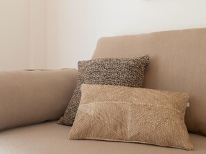 A beige sofa with two decorative pillows. - Central two-bedroom apartment (Málaga)