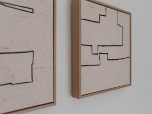 Two framed artworks with geometric patterns on a plain wall. - Central two-bedroom apartment (Málaga)