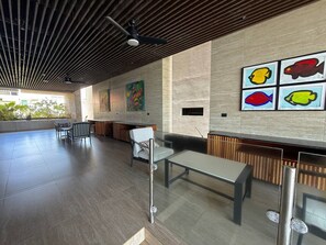 A spacious indoor area with a high ceiling and a seating arrangement.