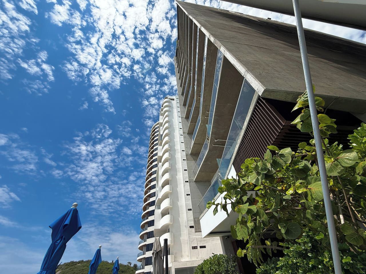 A modern building with a curved facade and multiple balconies.