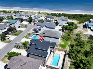 A residential area with houses, a swimming pool, and a beach in the background. - Oceanside, Private Pool, Dogs Welcome-OS6Q, Koo Koo's Nest (Corolla)