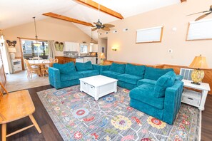A spacious living room with a large sectional sofa, a coffee table, and a patterned rug. - Oceanside, Private Pool, Dogs Welcome-OS6Q, Koo Koo's Nest (Corolla)
