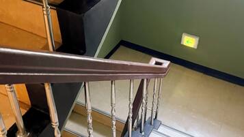 A staircase with a metal handrail and wooden steps.