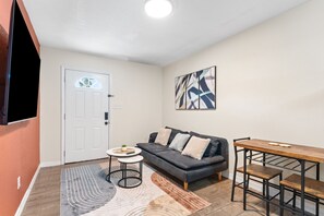 Settle into your bright, welcoming living space, where natural light and modern comfort come together. Unwind on the plush sofa, share meals at the dining table, and enjoy easy access to everything you need for a relaxing stay. - Remote Ready 1BR - Pet Friendly, 5 Min to Ybor (Tampa)