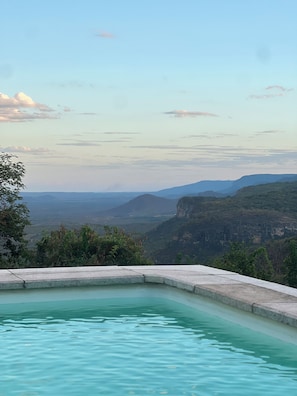 A swimming pool with a view of a mountainous landscape.