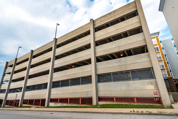 A multi-story parking garage with open parking spaces and a flat roof.