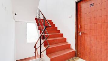 A staircase with red steps leading to a door marked 'G05'.