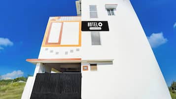A modern hotel with a sign indicating it is company-serviced.