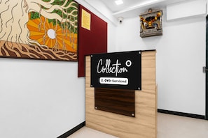 A reception desk with a sign that reads 'Collection' and 'YO-Serviced'. - Luxury Mkni House (Mumbai)