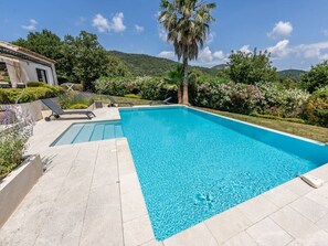A rectangular swimming pool with clear blue water, surrounded by a tiled deck. - Holiday Home in Grimaud With Swimming Pool (Grimaud)
