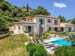 A two-story house with a swimming pool, outdoor seating, and a garden. - Holiday Home in Grimaud With Swimming Pool (Grimaud)