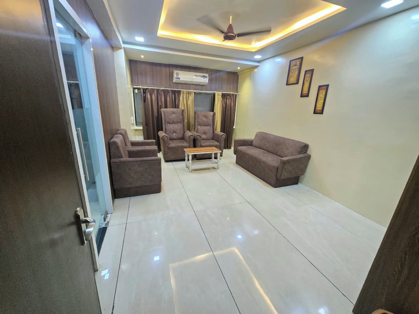 A modern living room with a sofa, armchairs, and a coffee table.