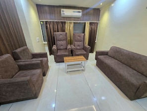A living room with two armchairs, a sofa, and a coffee table.