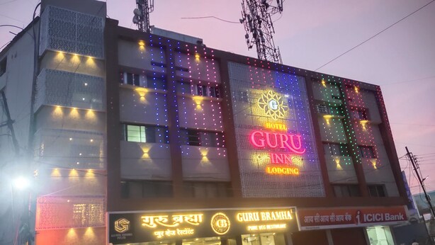A hotel with a prominent sign reading 'GURU INN LODGING.' - Hotel Guru Inn (Nanded)