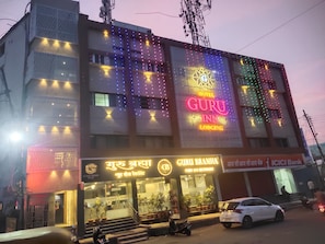 A hotel with a prominent sign reading 'GURU INN LODGING.'