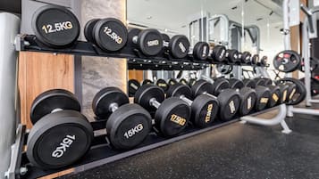 A rack of dumbbells with weights ranging from 10KG to 17.5KG.