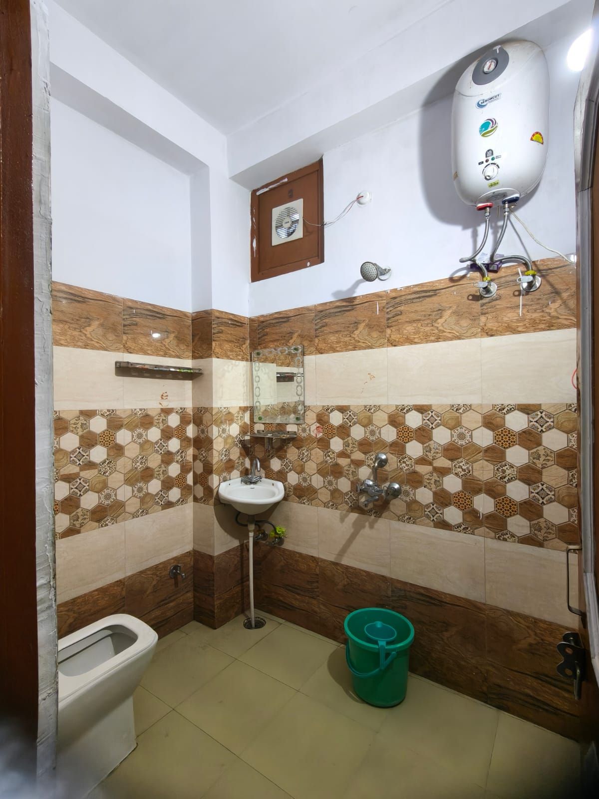 A bathroom with a toilet, sink, and shower.