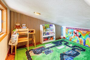 A child's playroom with a bookshelf, stuffed toys, and a colorful alphabet mural. - Deck & Views! Family Retreat Near RMNP (Grand Lake)