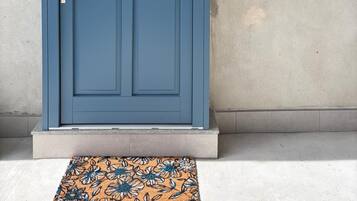 A blue door with a keyhole and a doorbell.