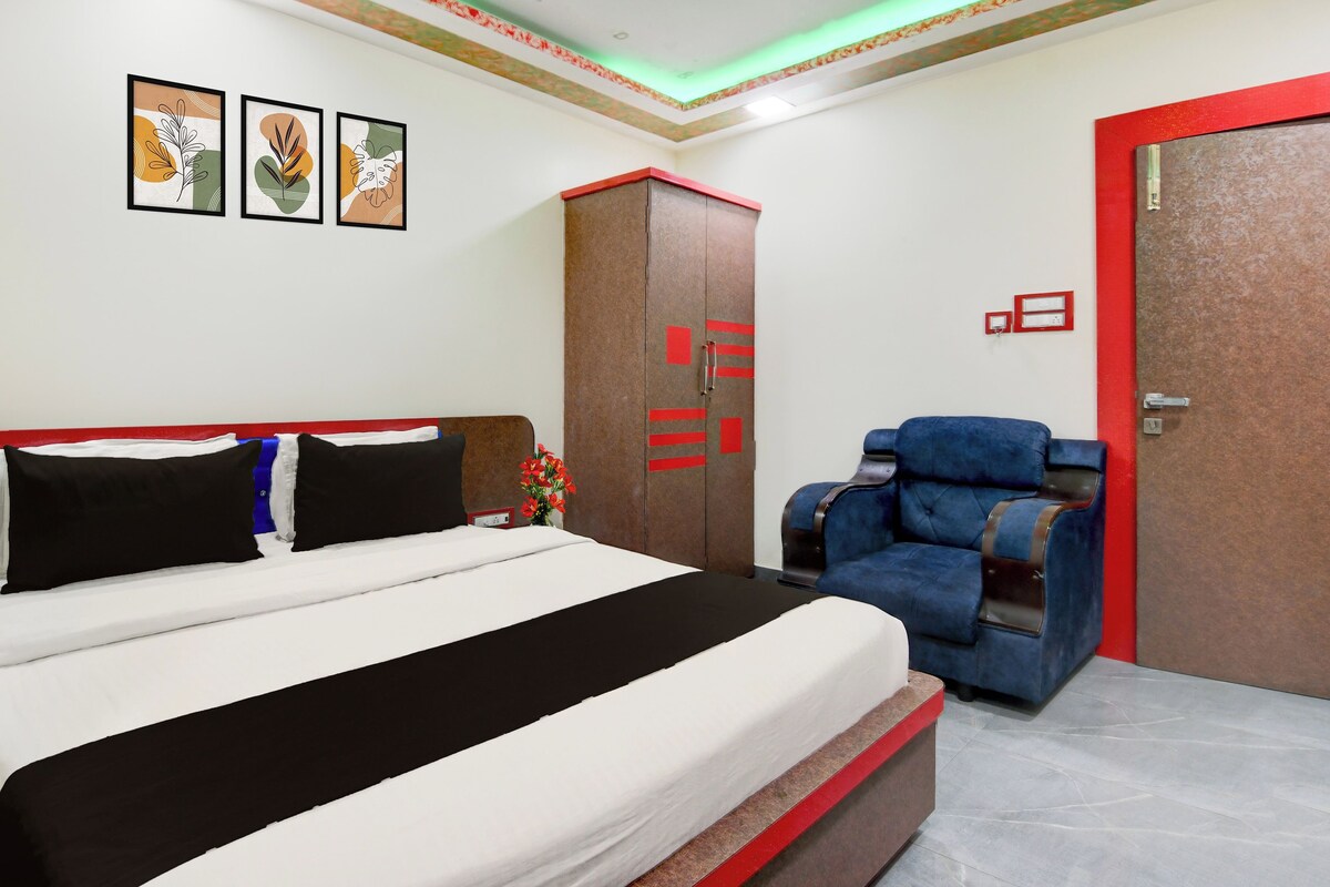 Una habitación de hotel con cama, armario, silla y puerta.