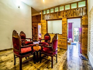 A wooden interior with a dining area featuring a table and four chairs.
