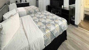 A hotel room with two beds, a desk, a TV, and a wardrobe. - 2 Full Beds | Non-Smoking, Kitchen (Phoenix)