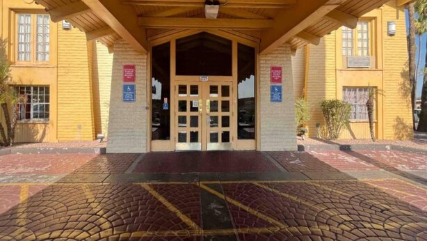 A building entrance with a covered porch, a double door, and a brick facade. - 2 Full Beds | Non-Smoking, Kitchen (Phoenix)