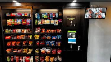 A self-checkout machine with a screen and payment terminal in a store.