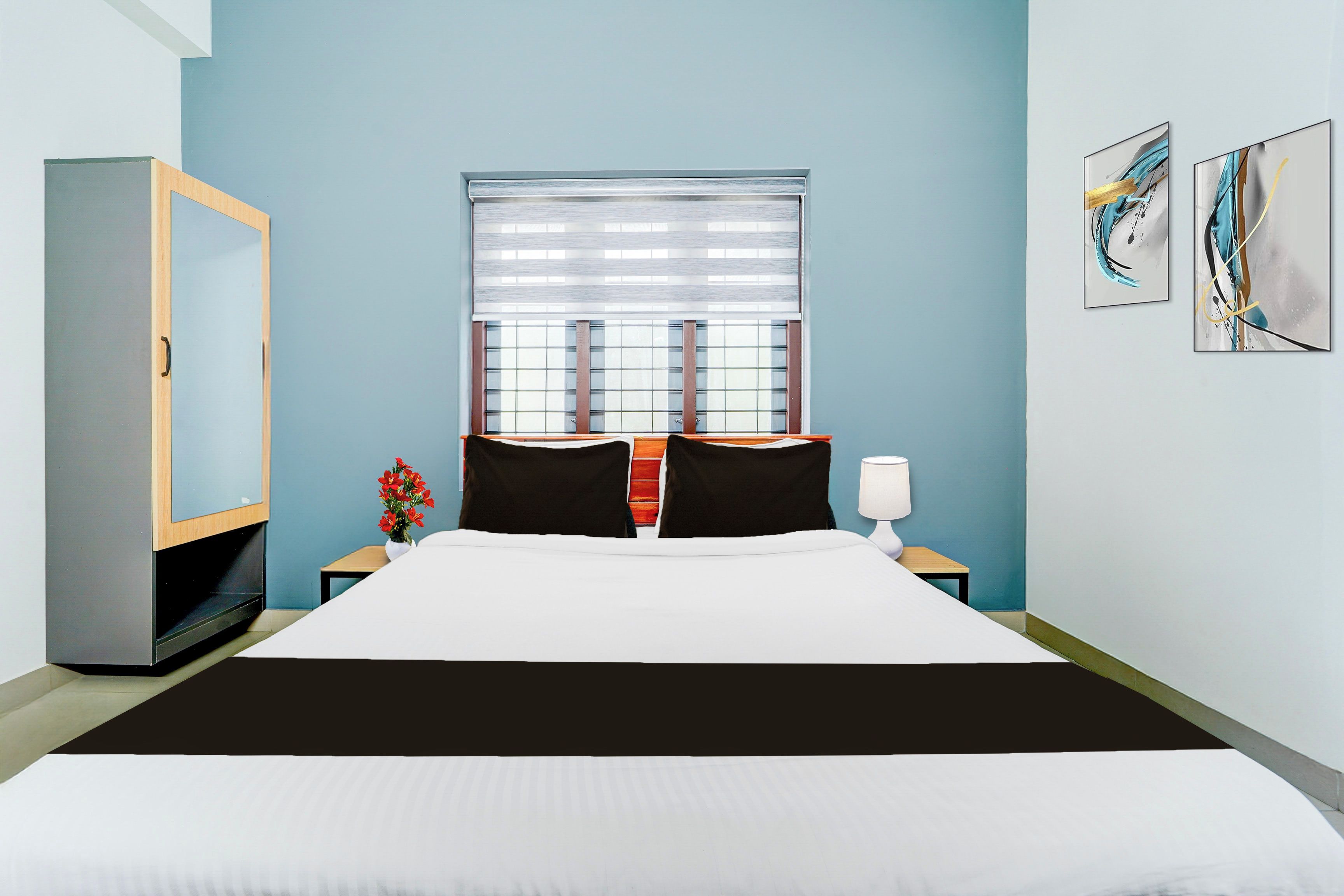 Una habitación de hotel con cama, mesita de noche, lámpara, cómoda y ventana con persianas.