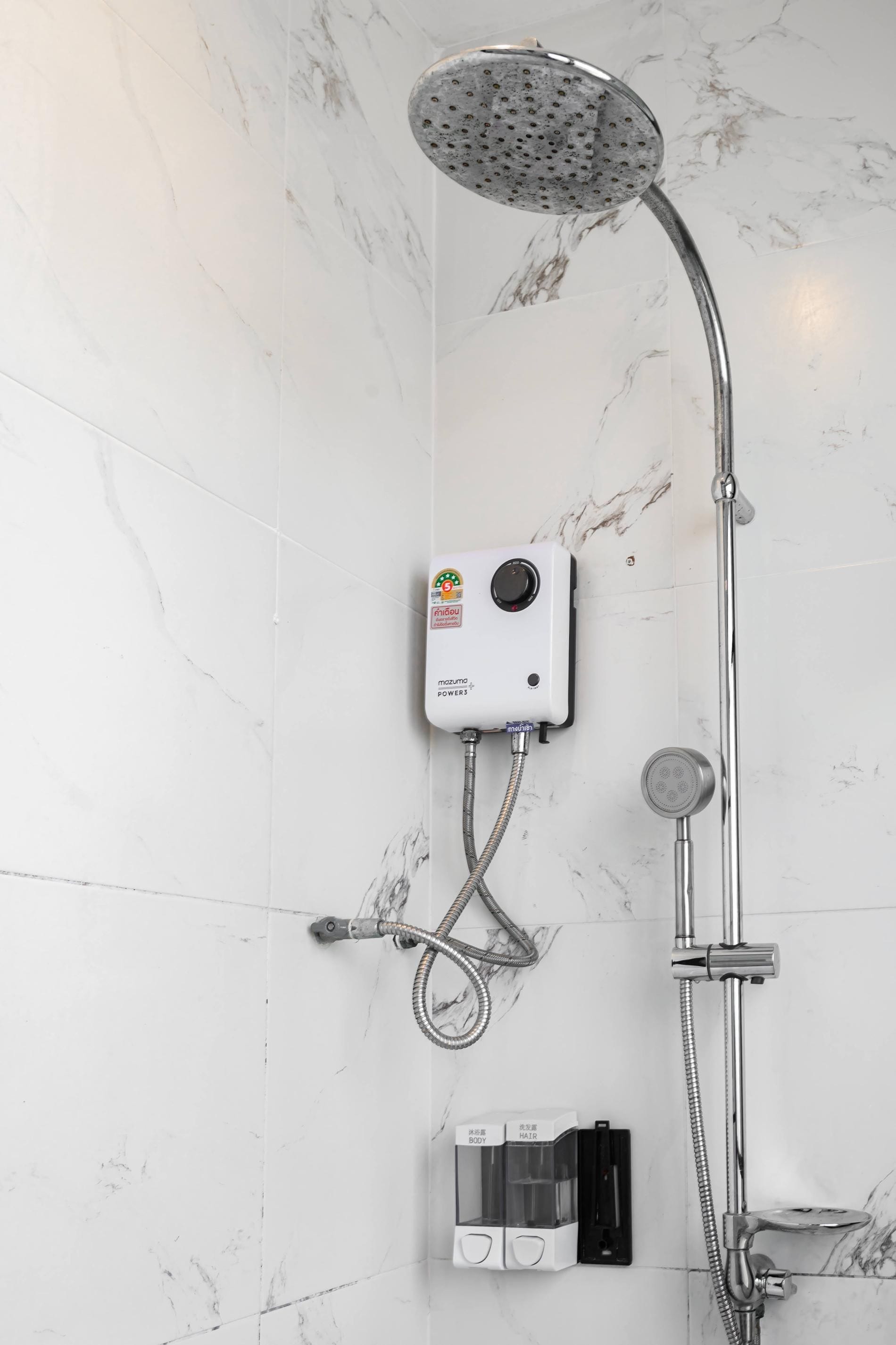 Ducha con cabezal de ducha manual, panel de control en la pared y grifo de mano.