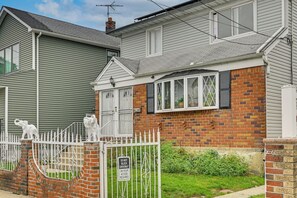 A residential area with houses, a gated entrance, and a 'DO NOT BLOCK DRIVEWAY' sign.
