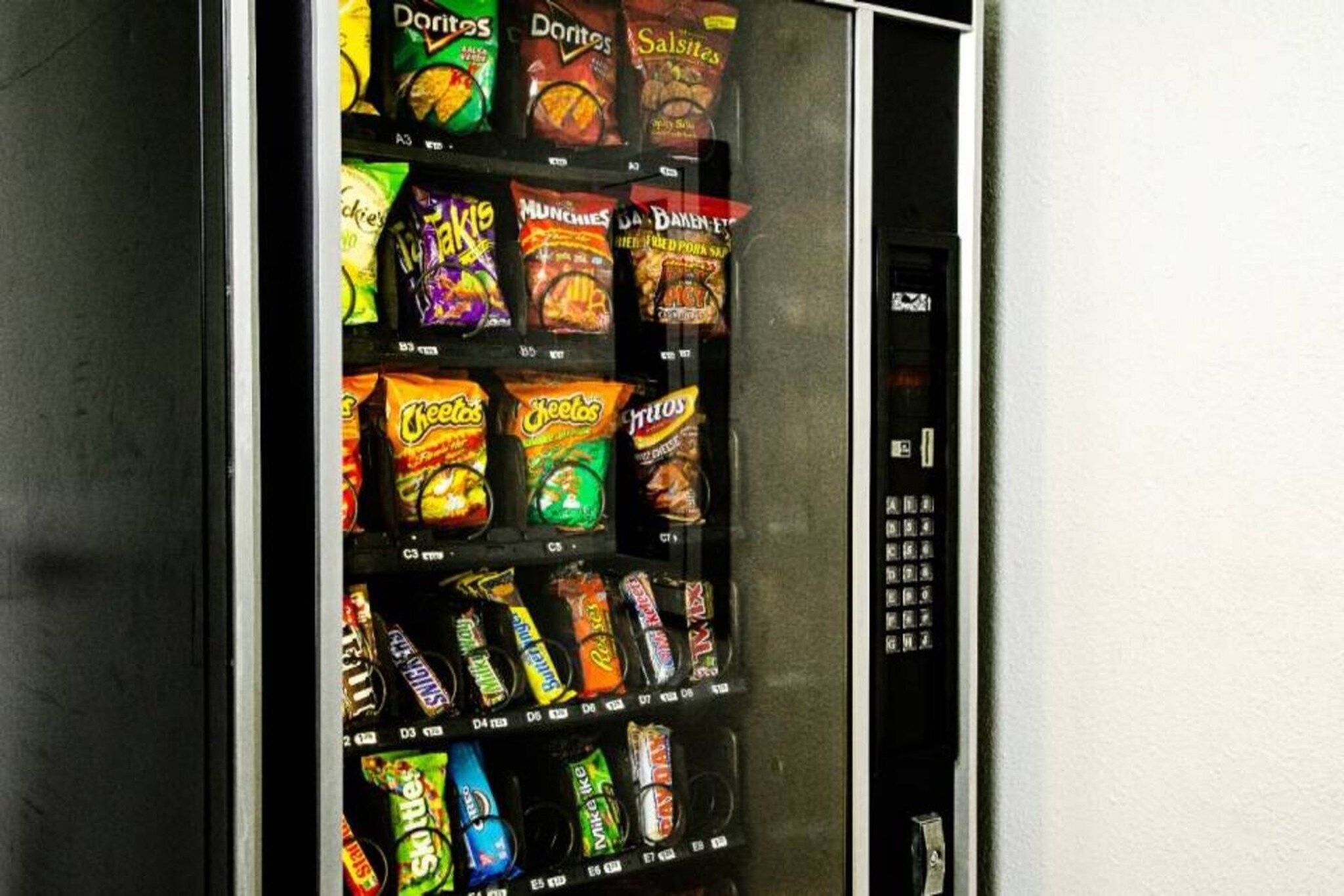 A vending machine stocked with various snack brands.