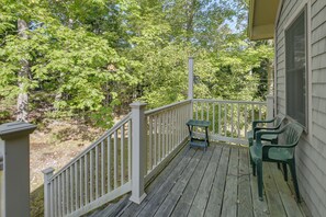 A wooden deck with a white railing, a small table, and two chairs. - Gateway to Acadia Nat'l Park! Peaceful Home (Ellsworth)