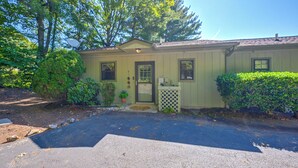 A single-story building with a front door, a small porch, and a mailbox.