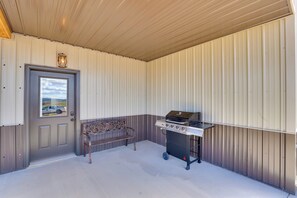 A covered patio area with a grill, a bench, and a door with a view. - Trail Access & Views! 90-Acre Haven in Hot Springs (Hot Springs)