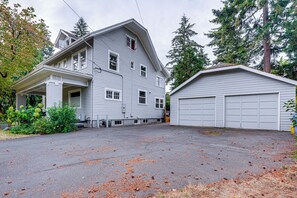 A two-story house with a garage, surrounded by trees and a driveway. - Home w/ Office & Yard, 5 Mi to Dtwn Portland! (Portland)