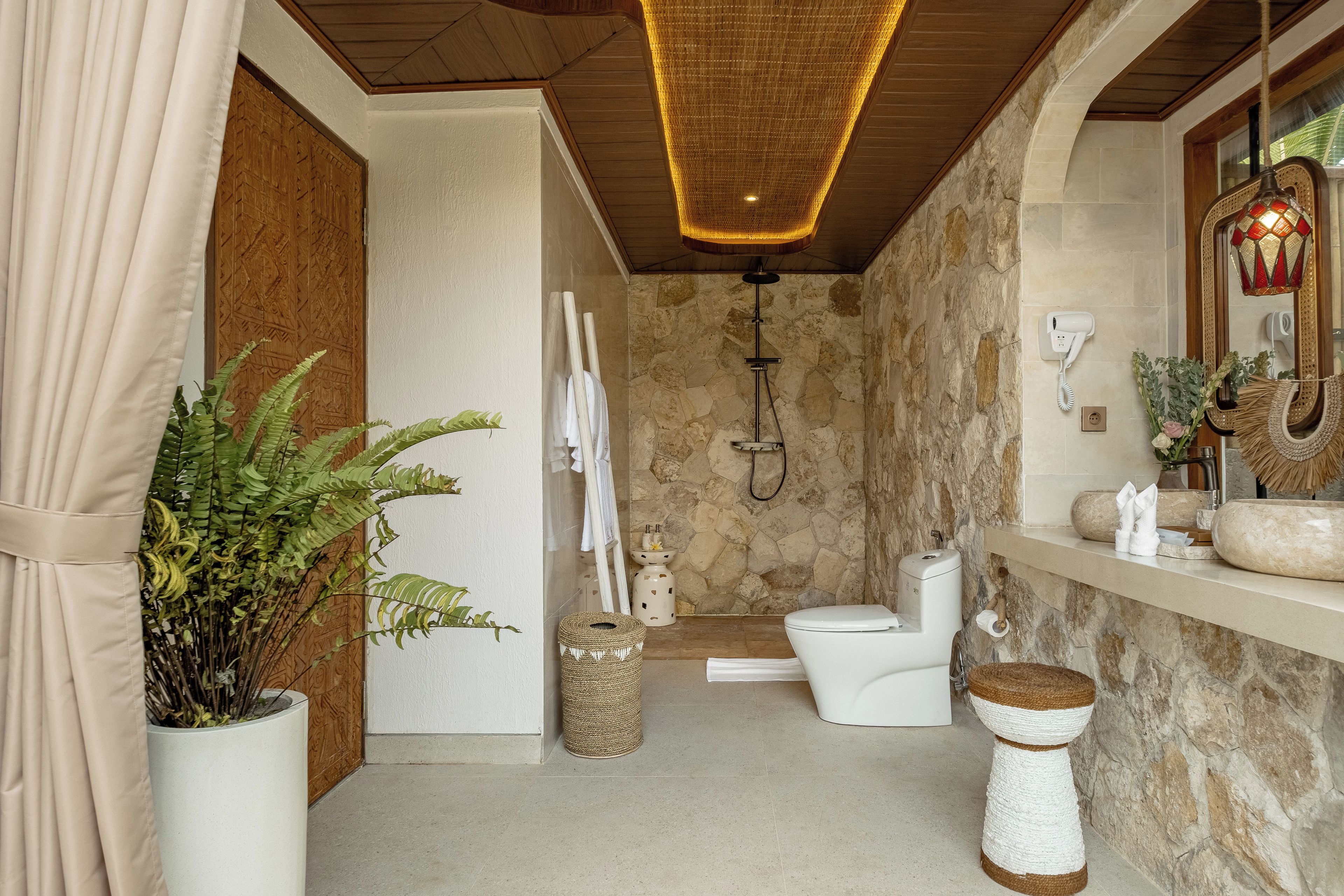 A bathroom with a shower, toilet, and a sink.
