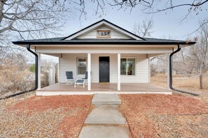 A single-story house with a covered porch, a front door, and two windows. - Spacious Duplex Duo: 14 Mi to Pearl Street Mall (Erie)
