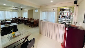 A hotel room with a dining area, a kitchen counter, and a minibar. - Hotel Janakpur Inn (Janakpur)