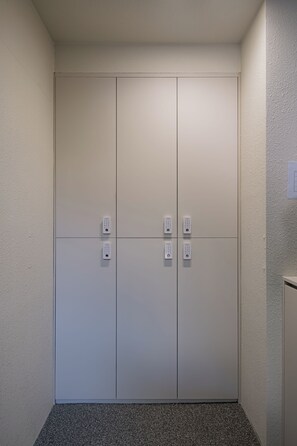 A clean, modern elevator with a textured wall and a simple design. - Grida Hongdae (Seoul)