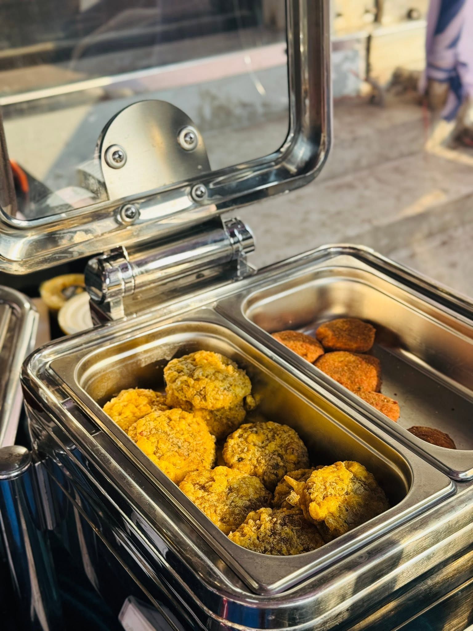 A buffet with various food items, including what appears to be fried balls and other snacks.