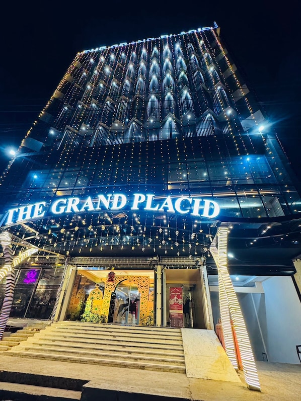 A building with a sign reading 'THE GRAND PLACE' and a staircase leading to the entrance. - The Grand Placid (Khulna)