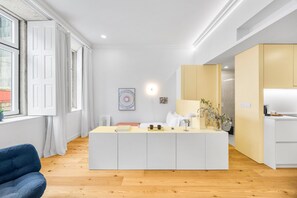 A modern living room with a central island, a sofa, and a window with curtains. - Sardina Living I (Porto)