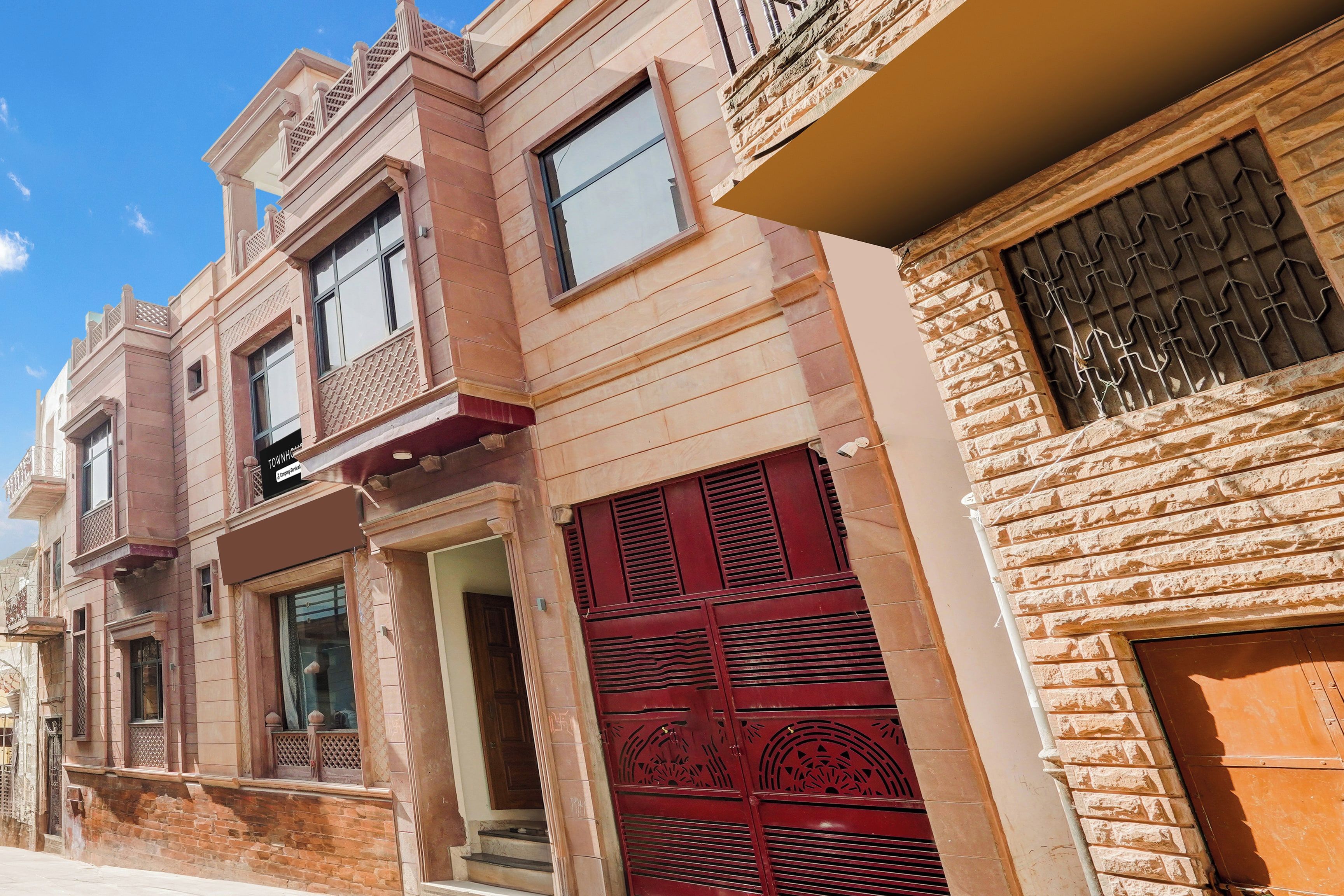 Una hilera de edificios tradicionales con detalles arquitectónicos característicos, como balcones ornamentados y celosías en las ventanas.
