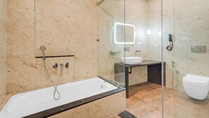 A modern bathroom with a glass-enclosed shower, a standalone bathtub, and a vanity with a mirror. - Townhouse Jodhpur Clock Tower (Jodhpur)