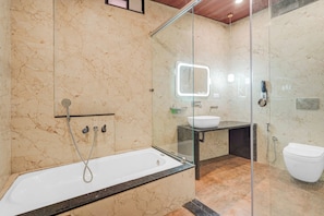 A modern bathroom with a glass-enclosed shower, a standalone bathtub, and a vanity with a mirror. - Townhouse Jodhpur Clock Tower (Jodhpur)